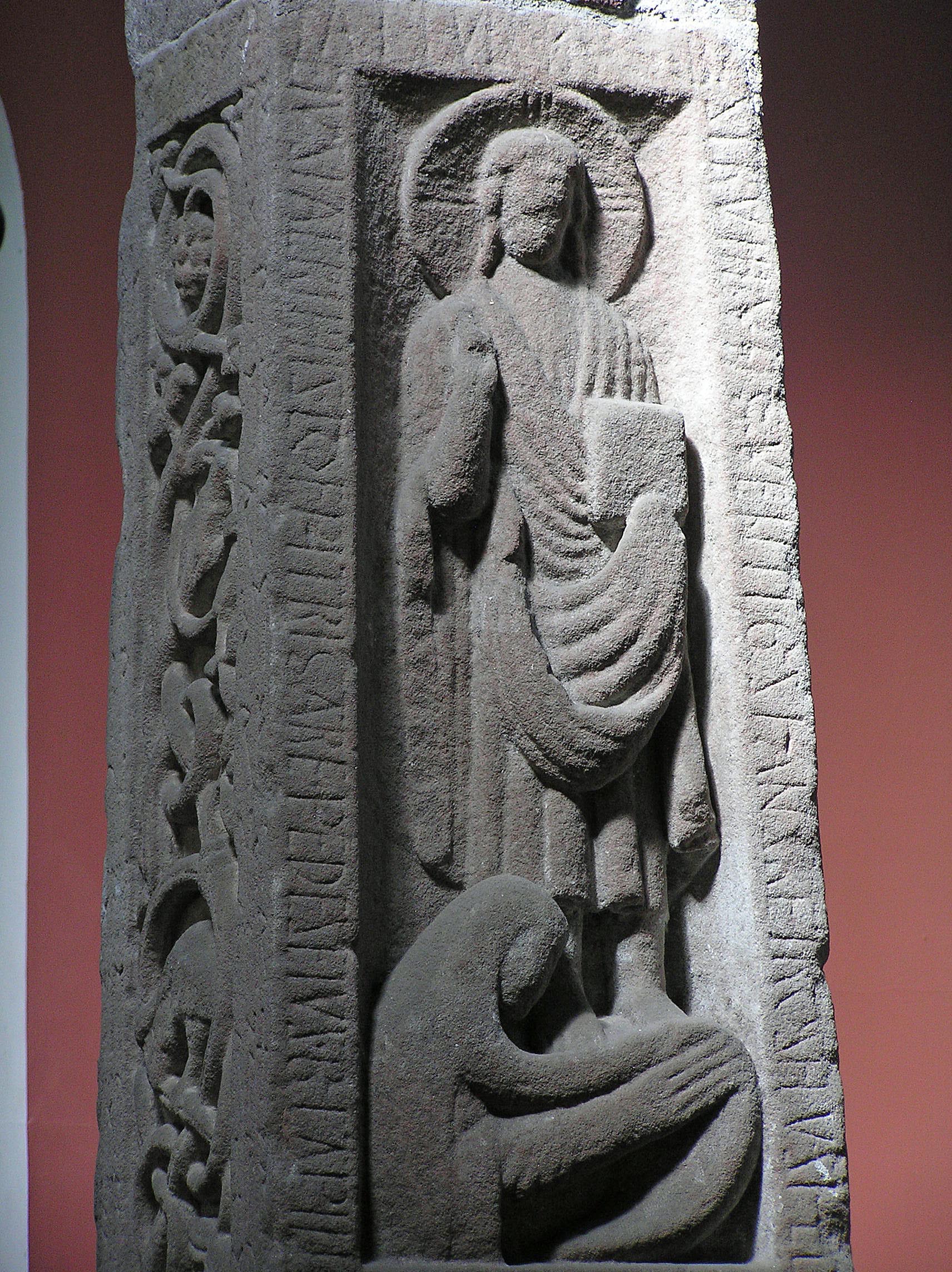 Detail of the Ruthwell Cross showing Christ figure with runic inscriptions visible along the sides